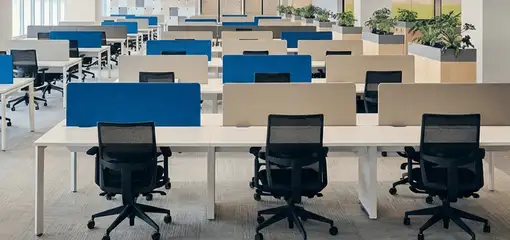 Modern open-plan office space featuring clean workstations, ergonomic chairs, and sanitized carpets provided by professional office cleaning services in Boise, ID.