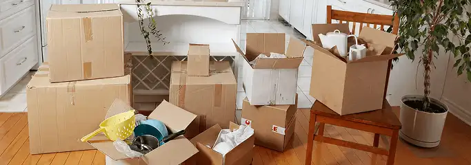 Packed moving boxes and household items in a kitchen before move-out or move-in cleaning, Boise, ID.